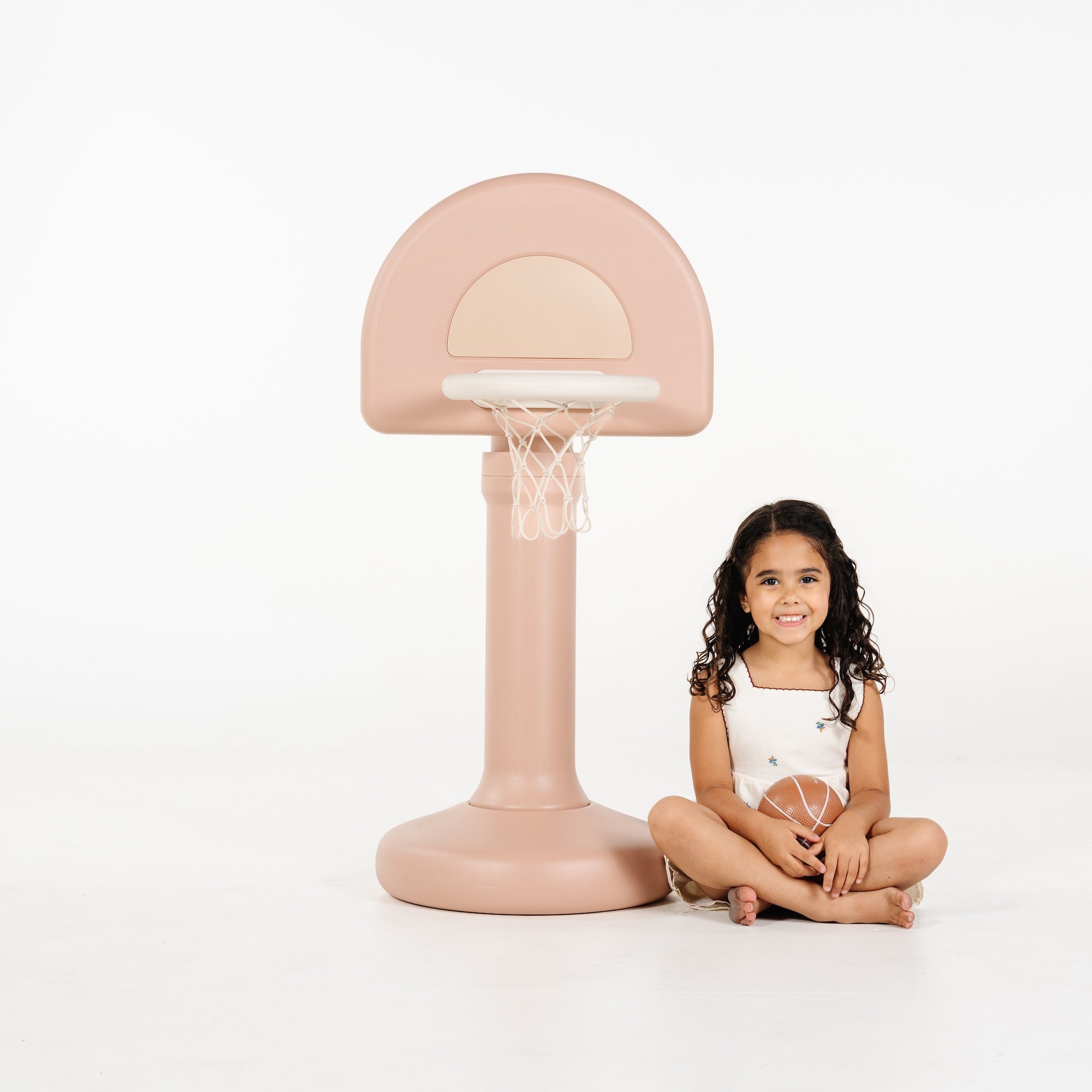Tulle@Toddler using a basketball hoop to practice coordination and movement