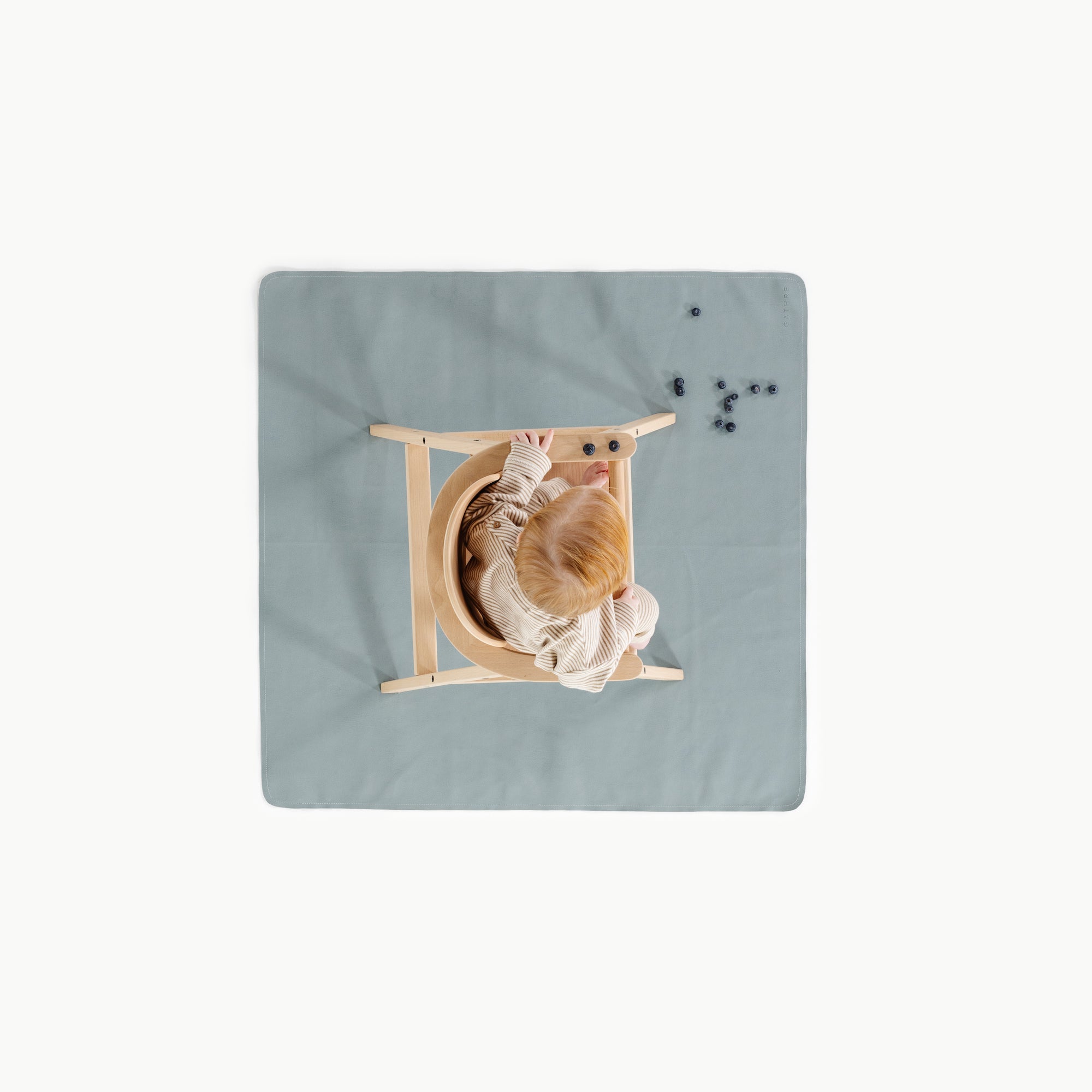 Amalfi (on sale)@overhead of baby in high chair on mat