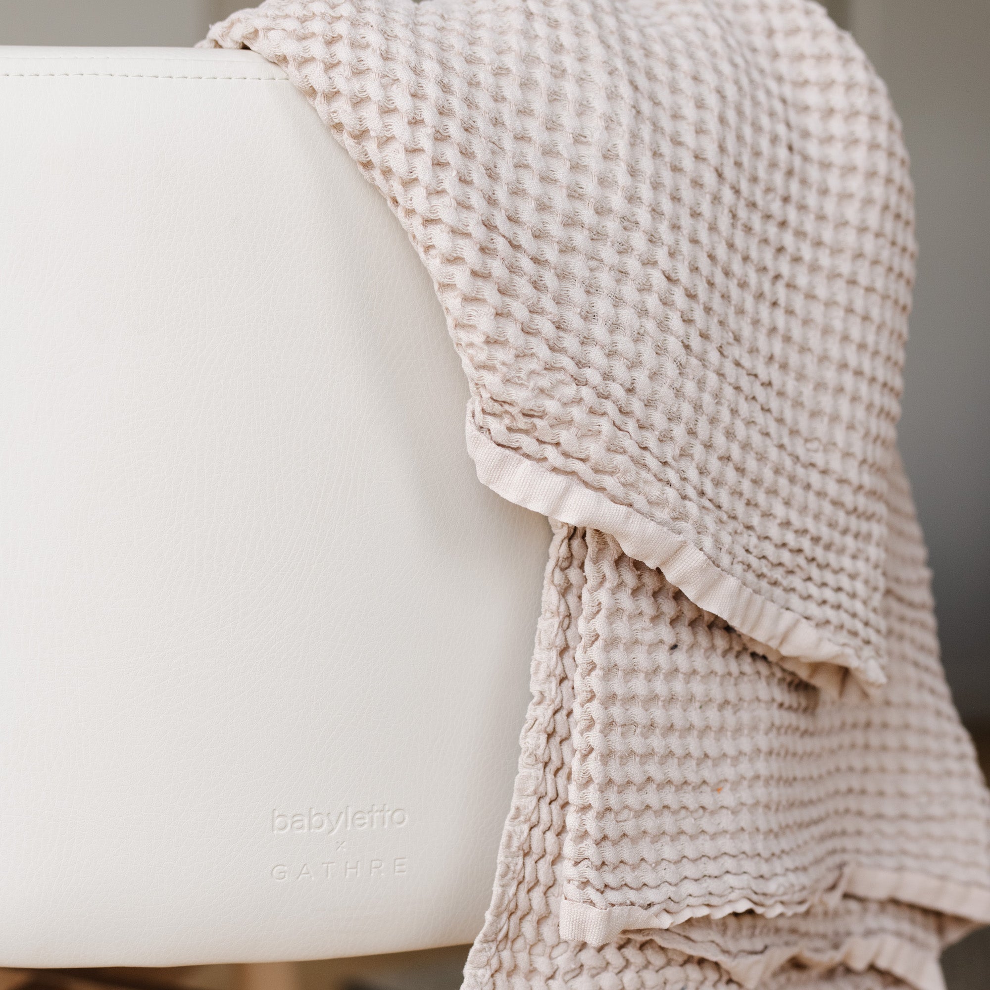 Ivory@Close up of Ivory Bassinet logo