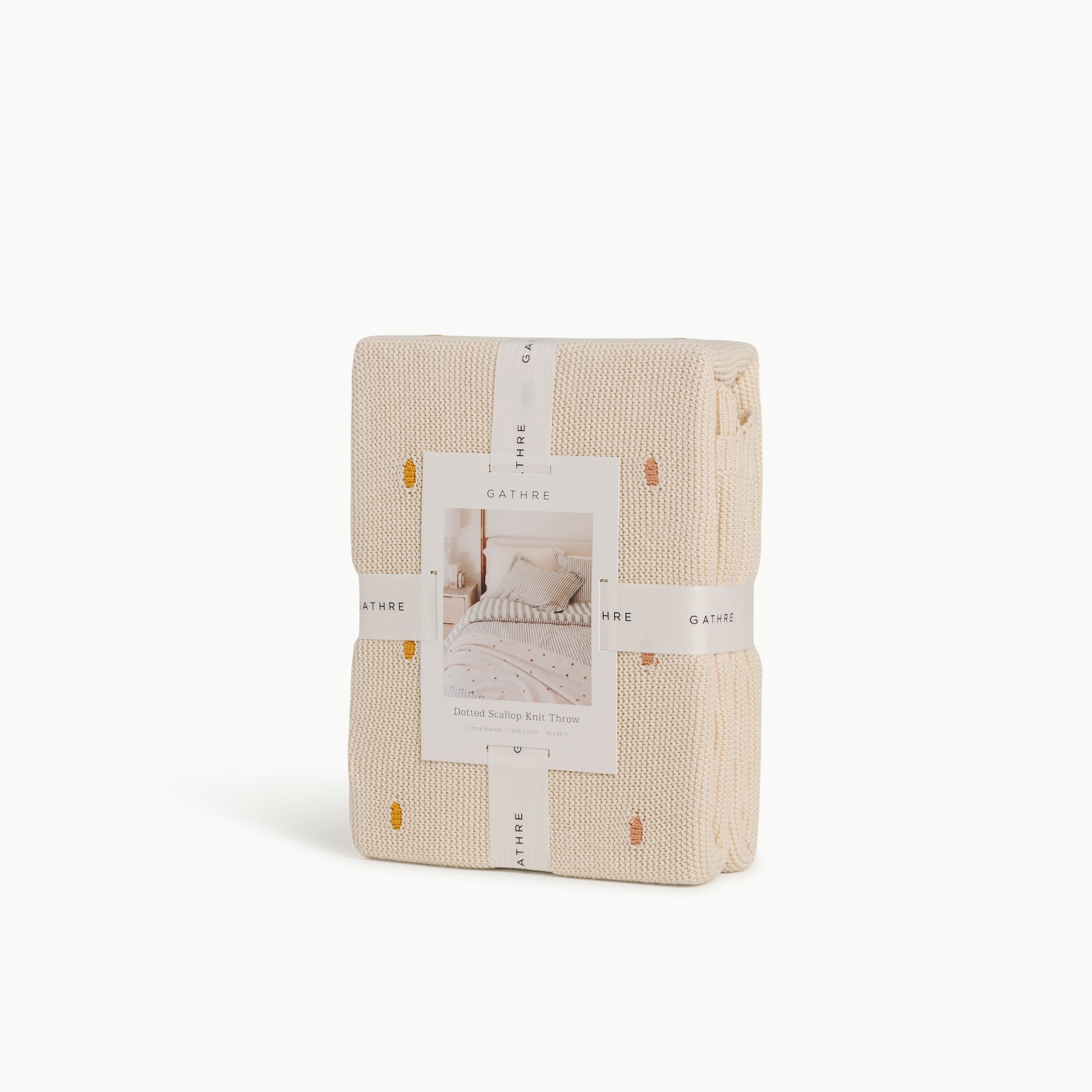 Ivory@Cotton knit throw blanket with dotted texture and scalloped edge in packaging