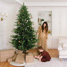 Ivory (on sale)@Gathre Tree Skirt under a tree in a home with people around it