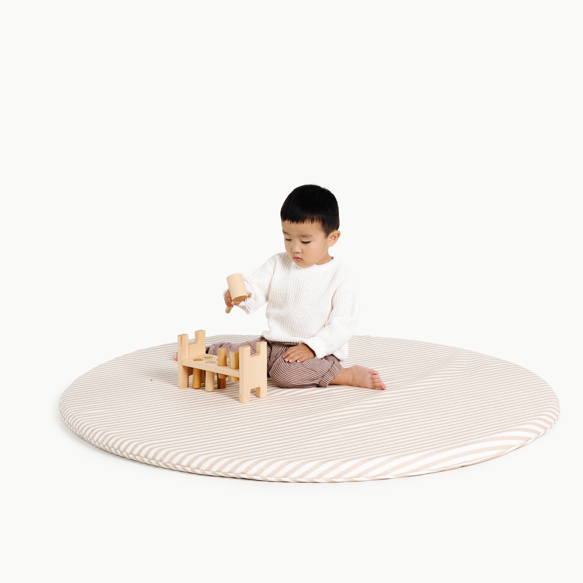 Cafe Stripe@kid playing on the cafe stripe padded midi circle