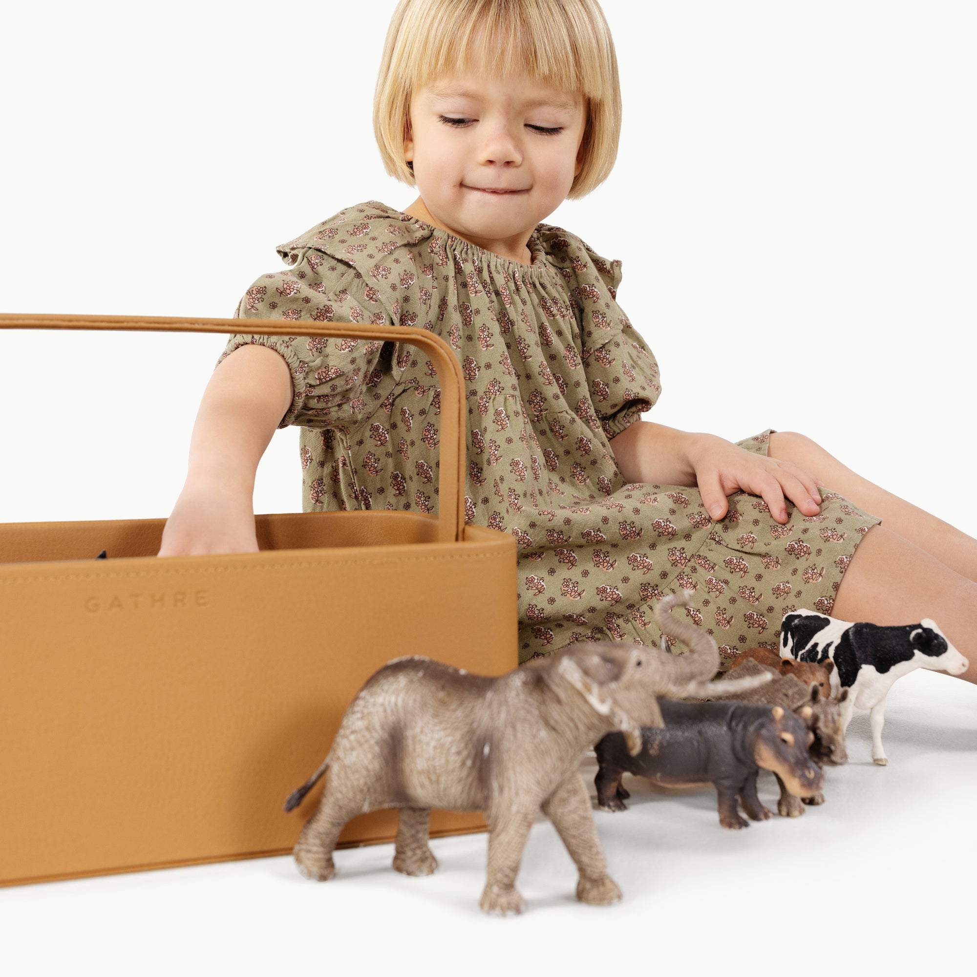 Camel@kid playing with toys from the small camel caddy
