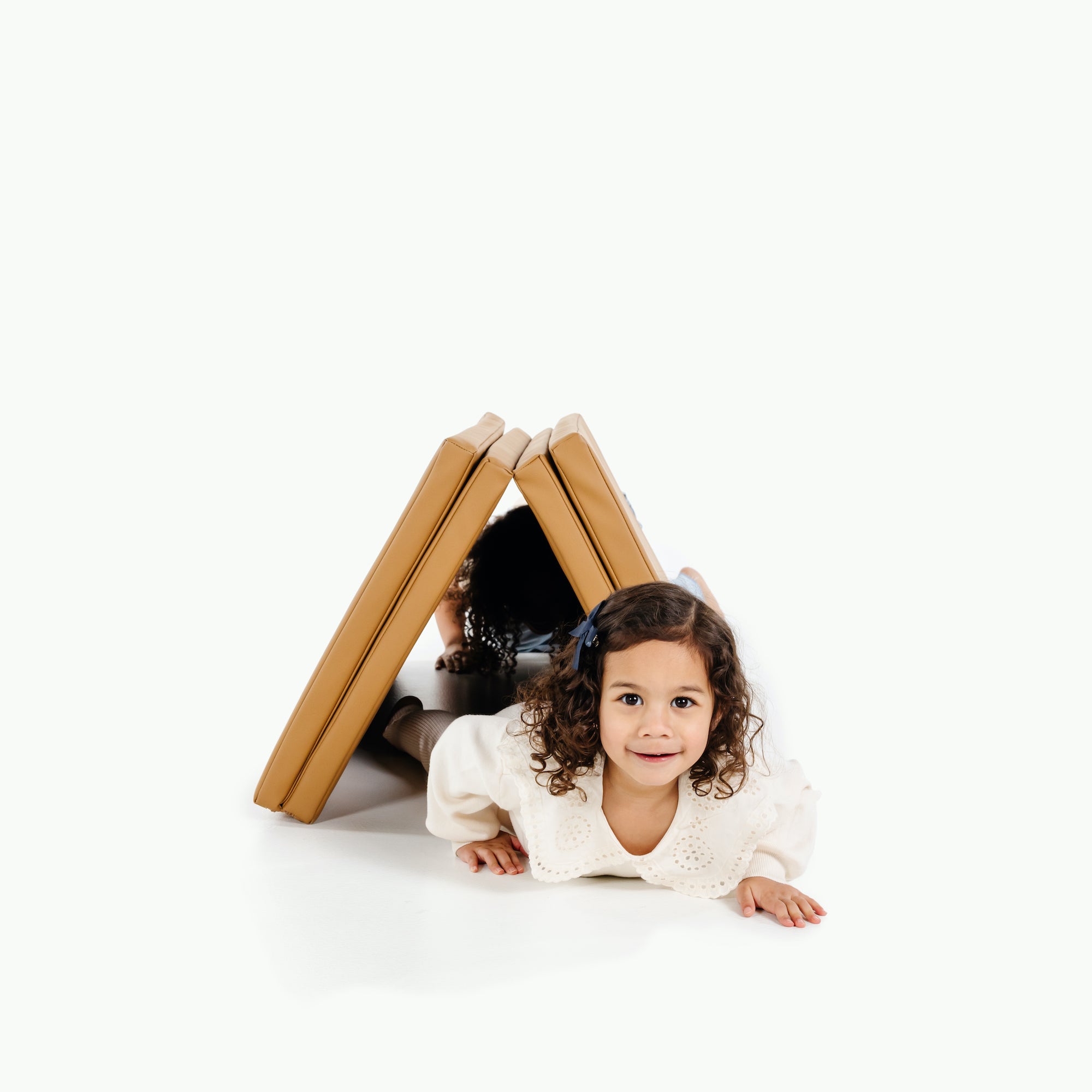 Camel@Kids crawling under propped up Camel Tumbling Mat