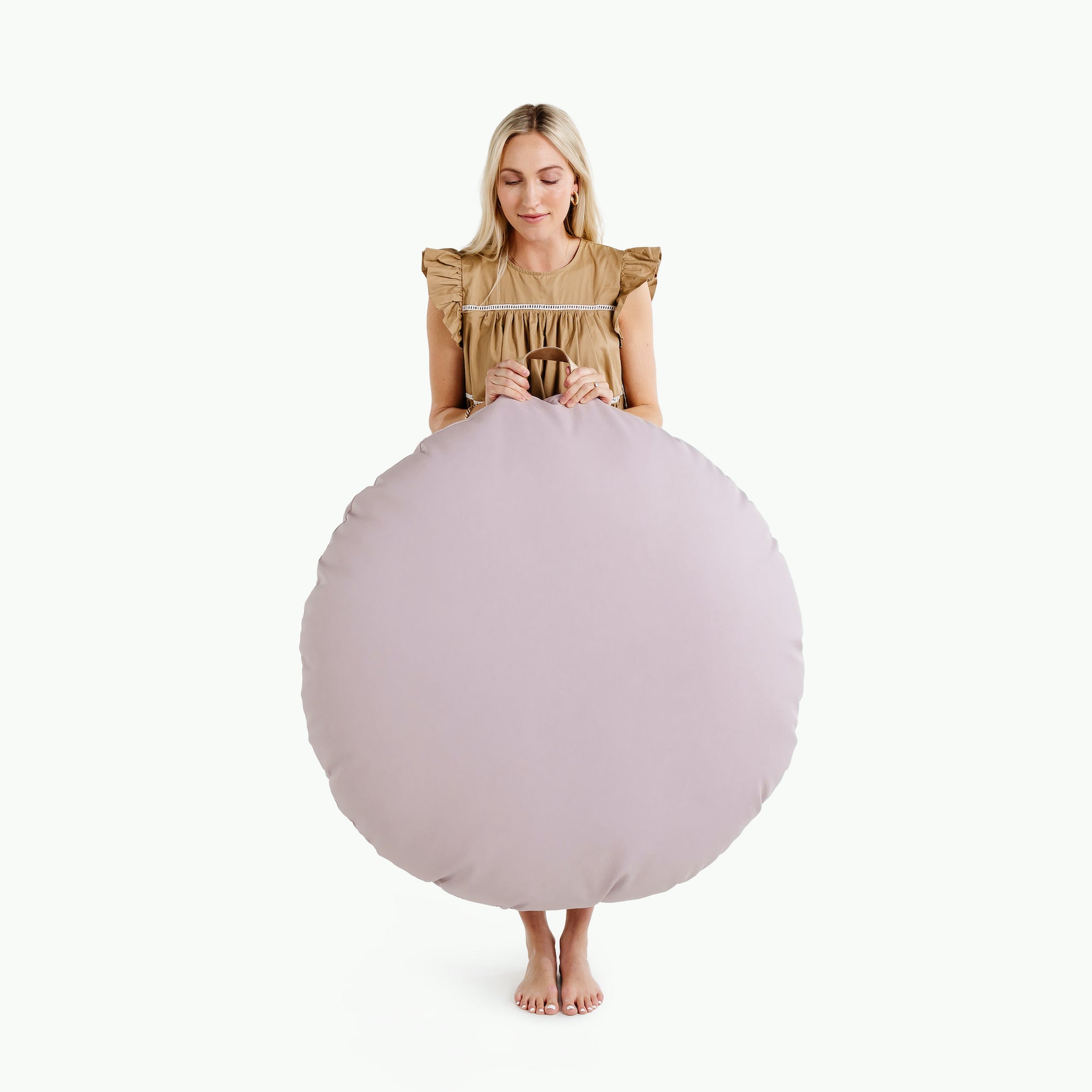 Fable (on sale) / Circle@woman holding up the fable circle floor cushion