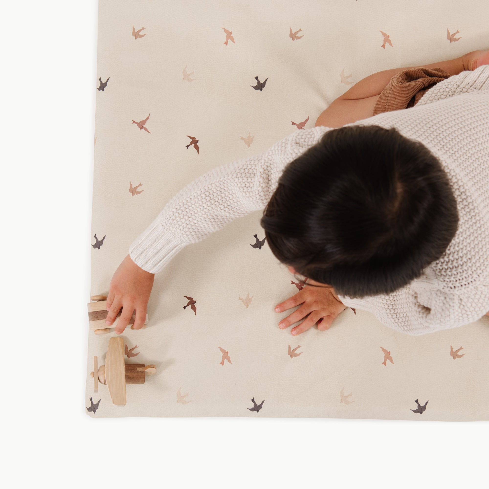 Tiny Wings (on sale)@overhead of kid sitting on padded midi+