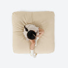 Créme (on sale) / Square@overhead of girl sitting on cushion