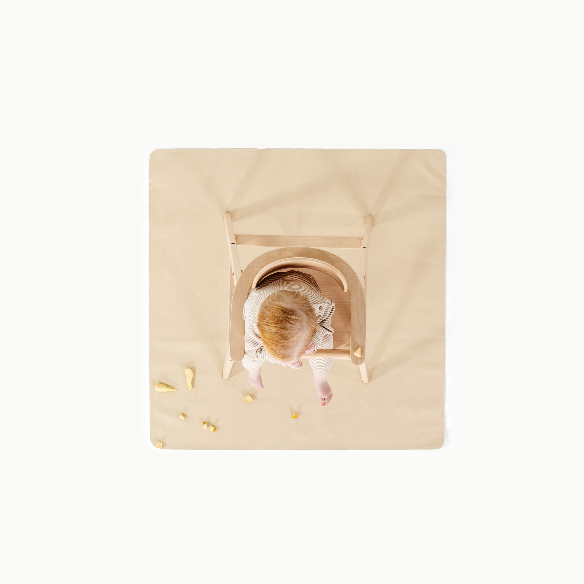 Créme (on sale)@overhead of baby in high chair on mat