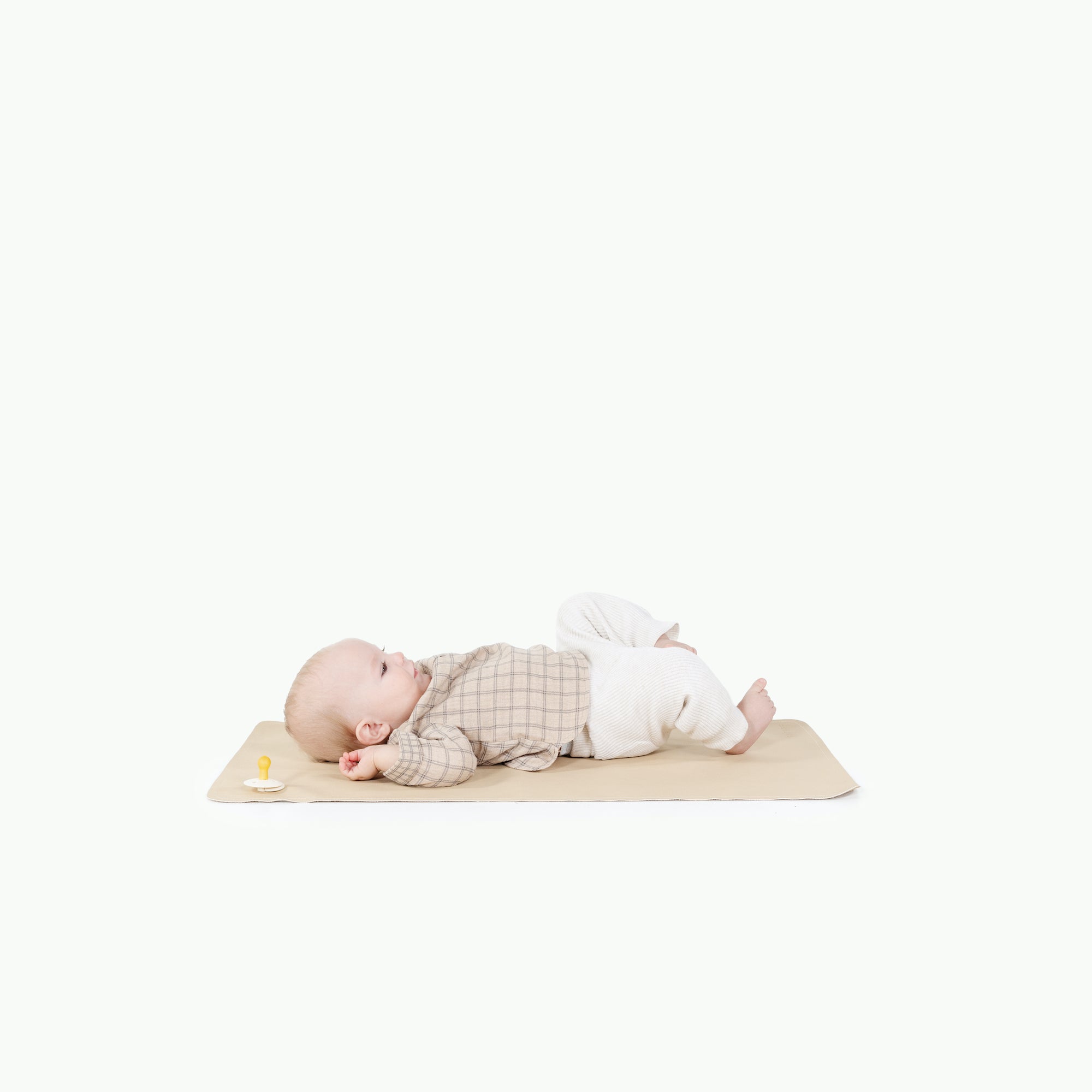 Créme (on sale)@baby laying on the créme micro+ mat