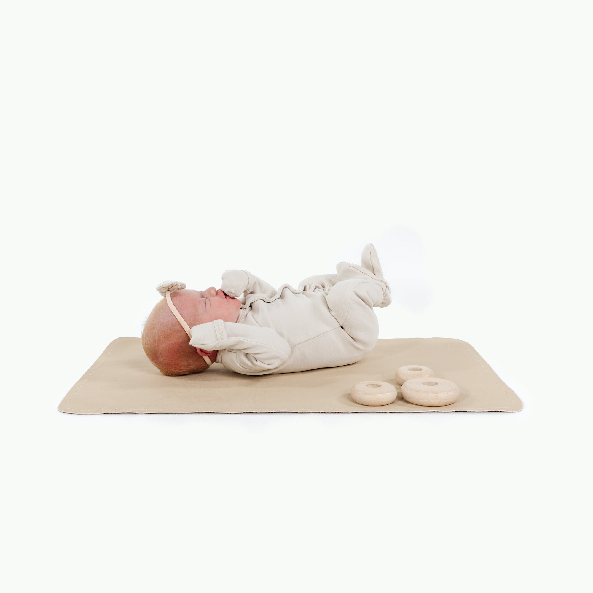 Créme (on sale)@baby laying on the créme micro mat