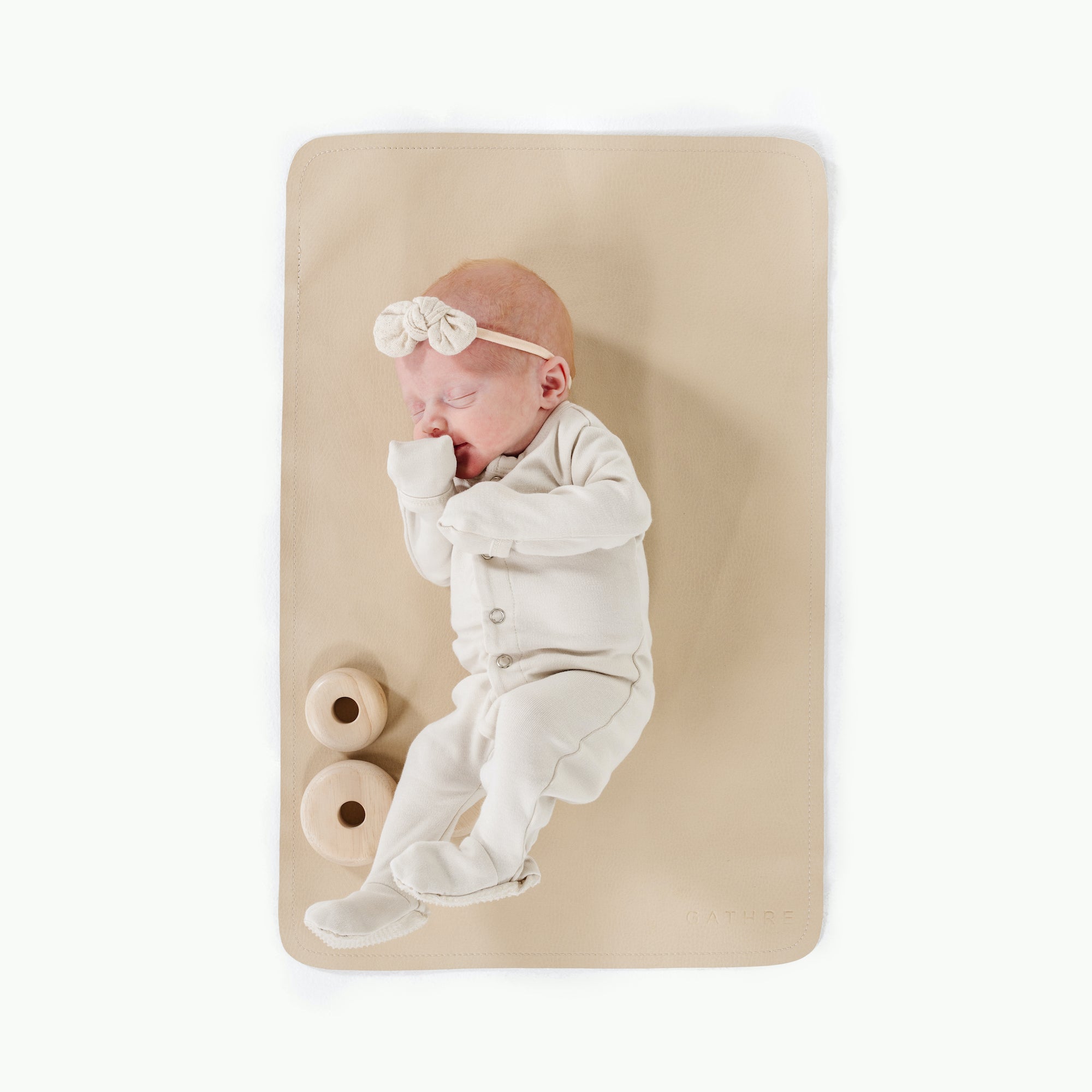 Créme (on sale)@overhead of baby laying on the créme micro mat