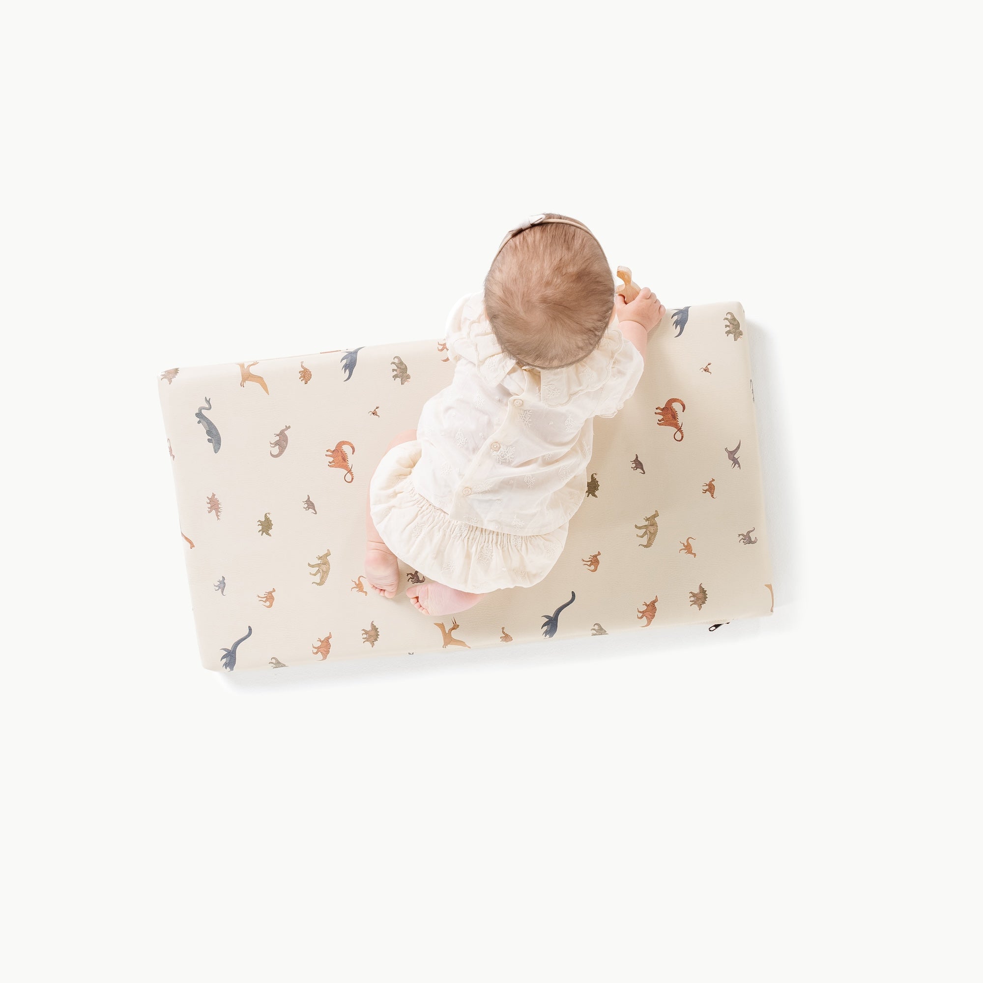 Dinosauria (on sale)@overhead of baby on padded micro+