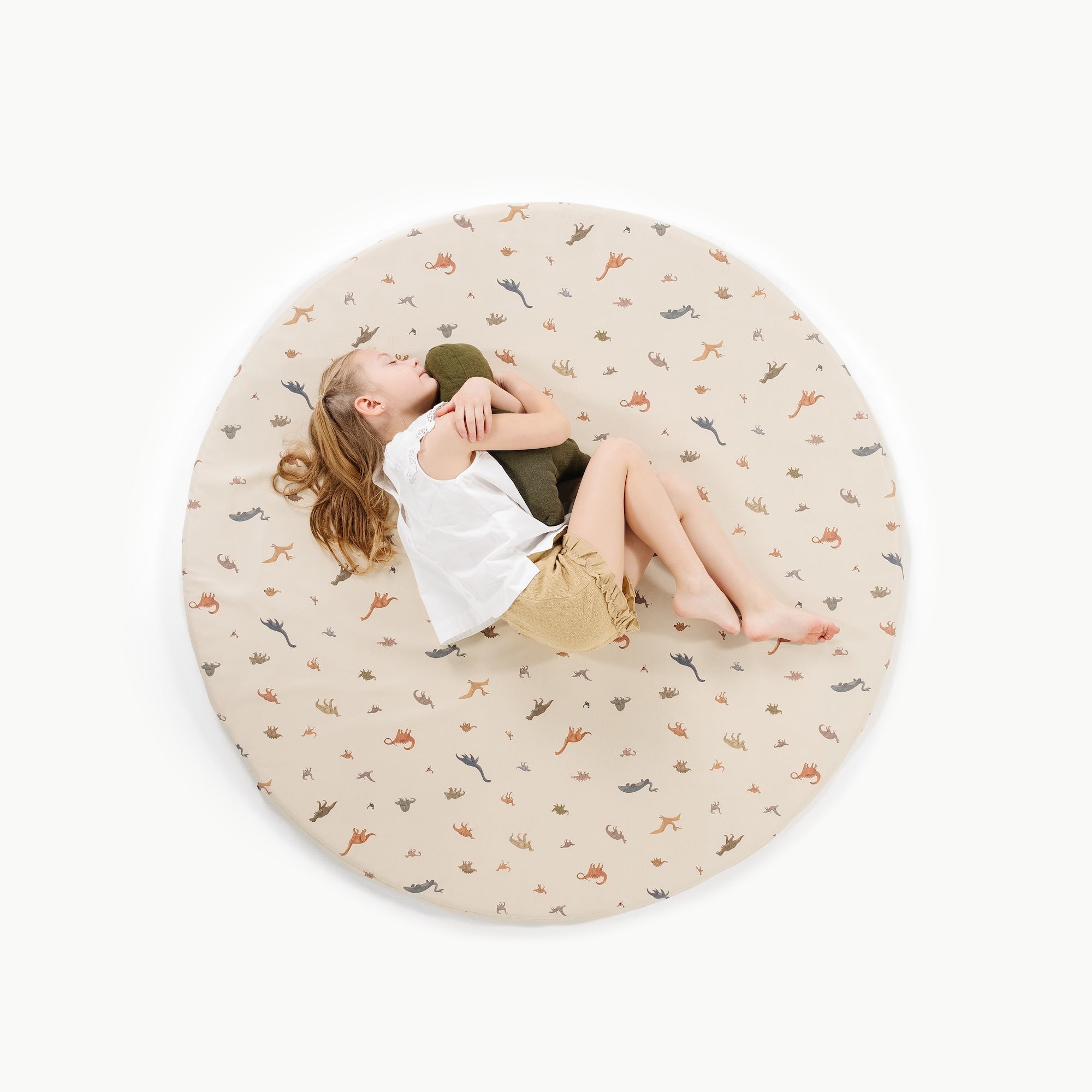 Dinosauria (on sale)@overhead of little girl sitting on padded midi