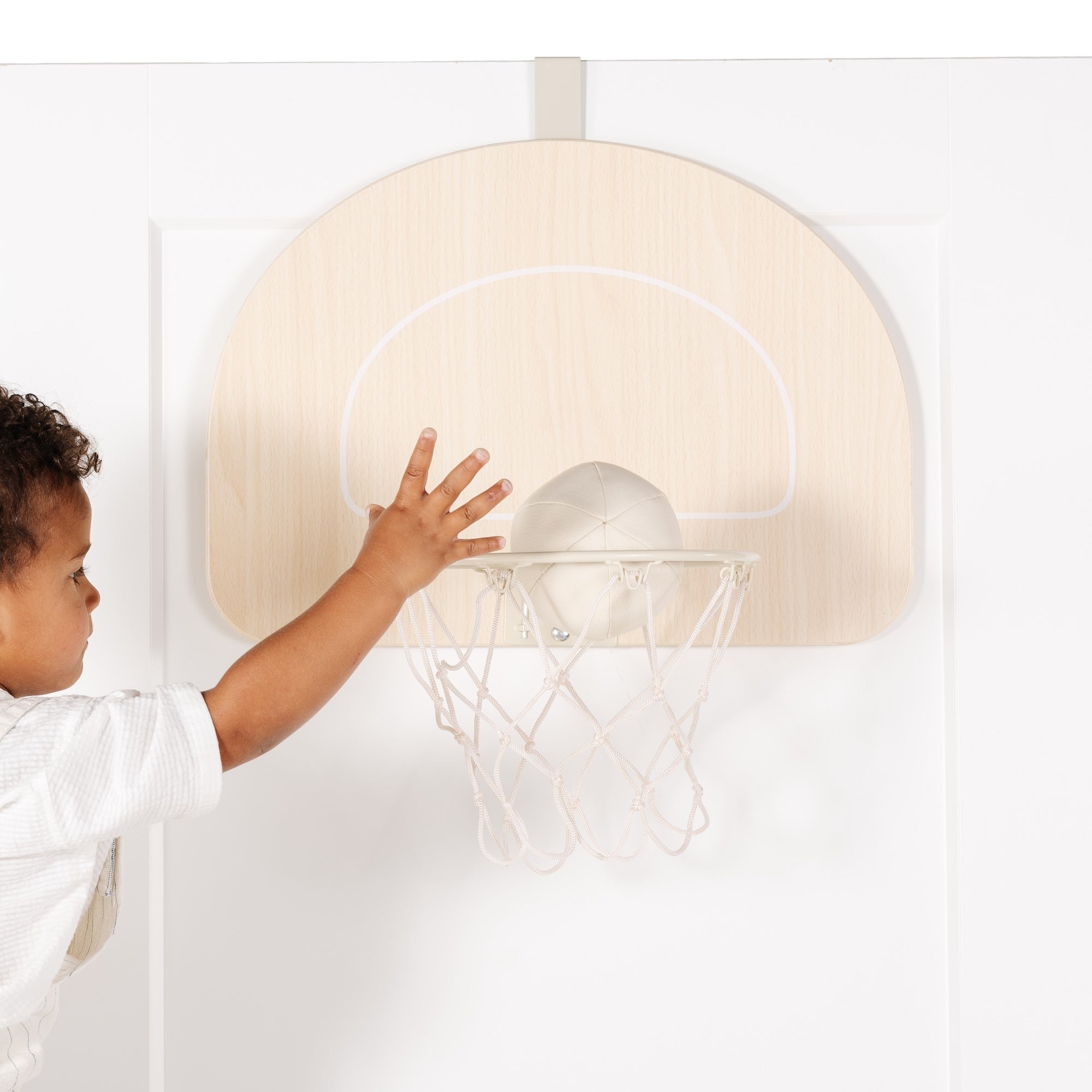 All@boy playing with basketball hoop