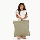 Fern (on sale) / Square@kid holding the fern mini square floor cushion