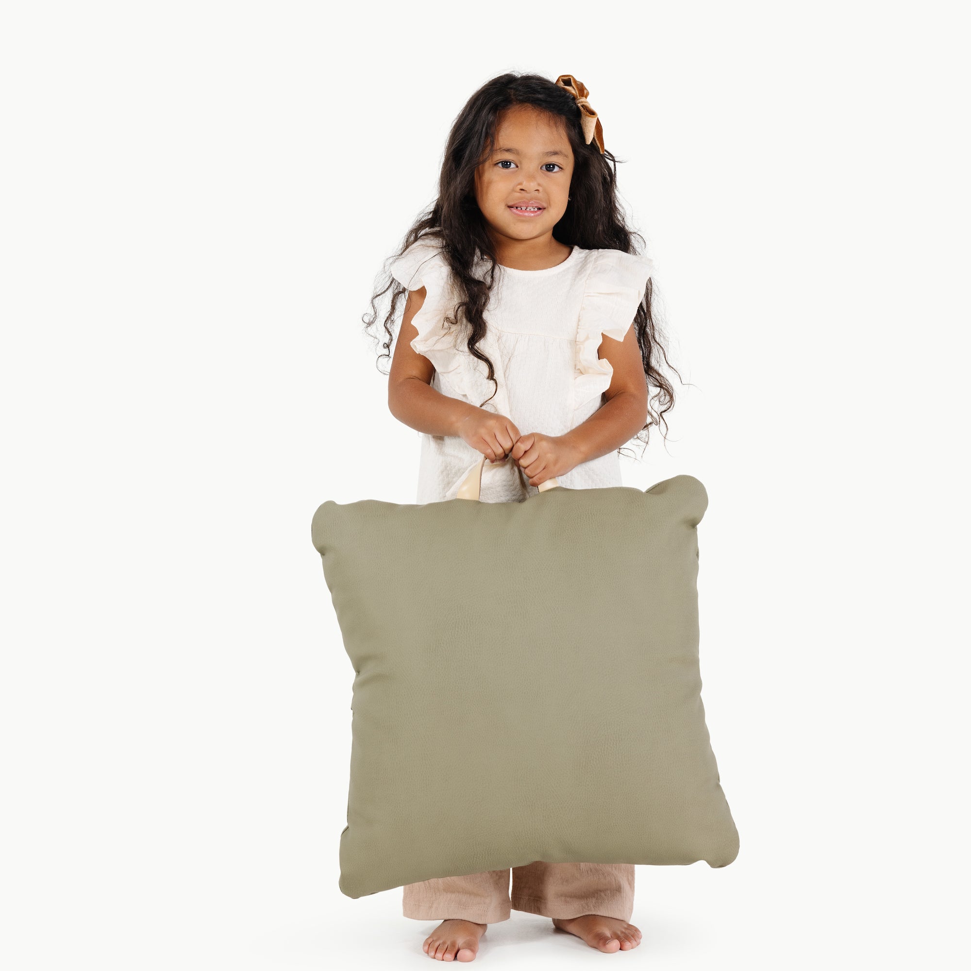 Fern (on sale) / Square@kid holding the fern mini square floor cushion