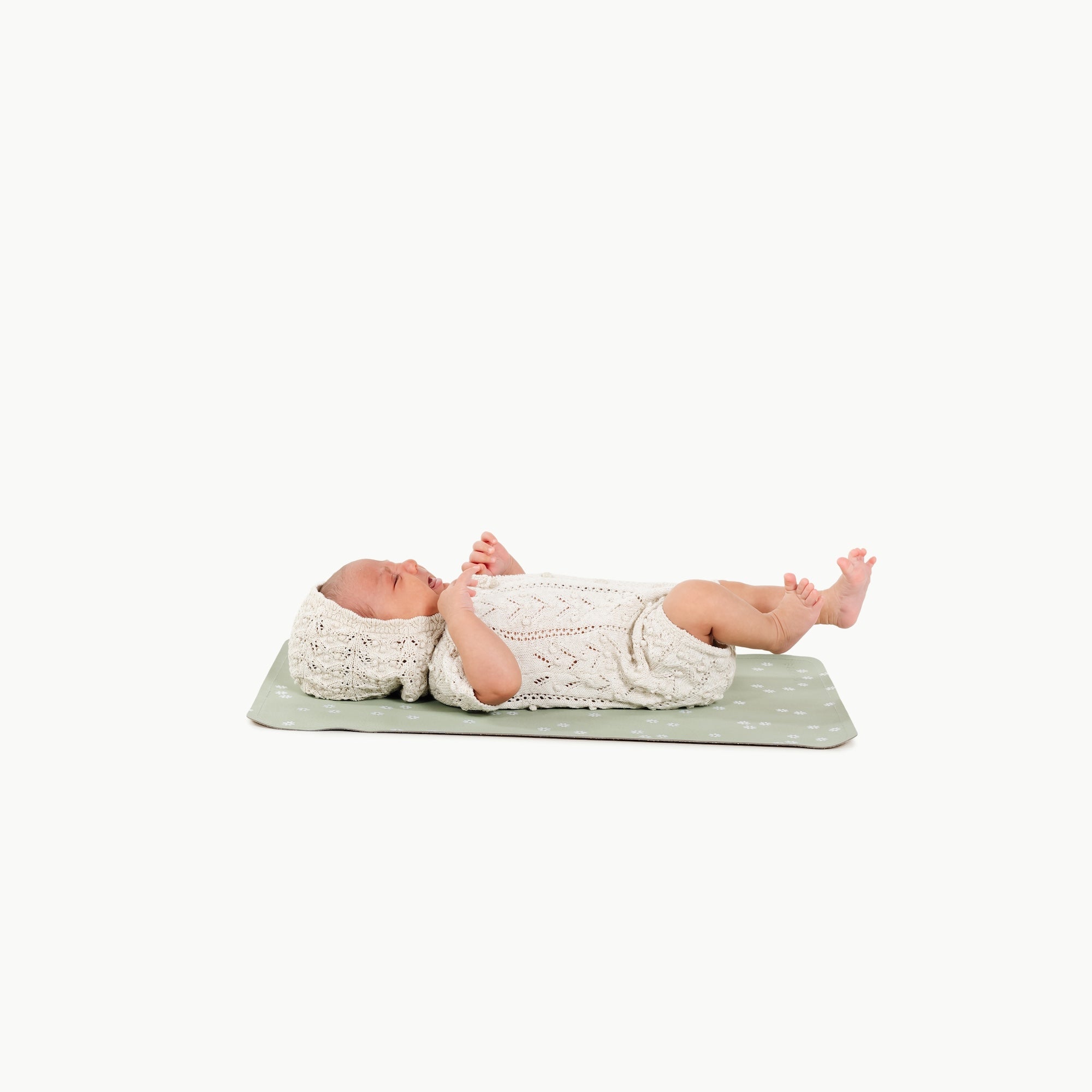 Flora@baby lying on a micro changing mat