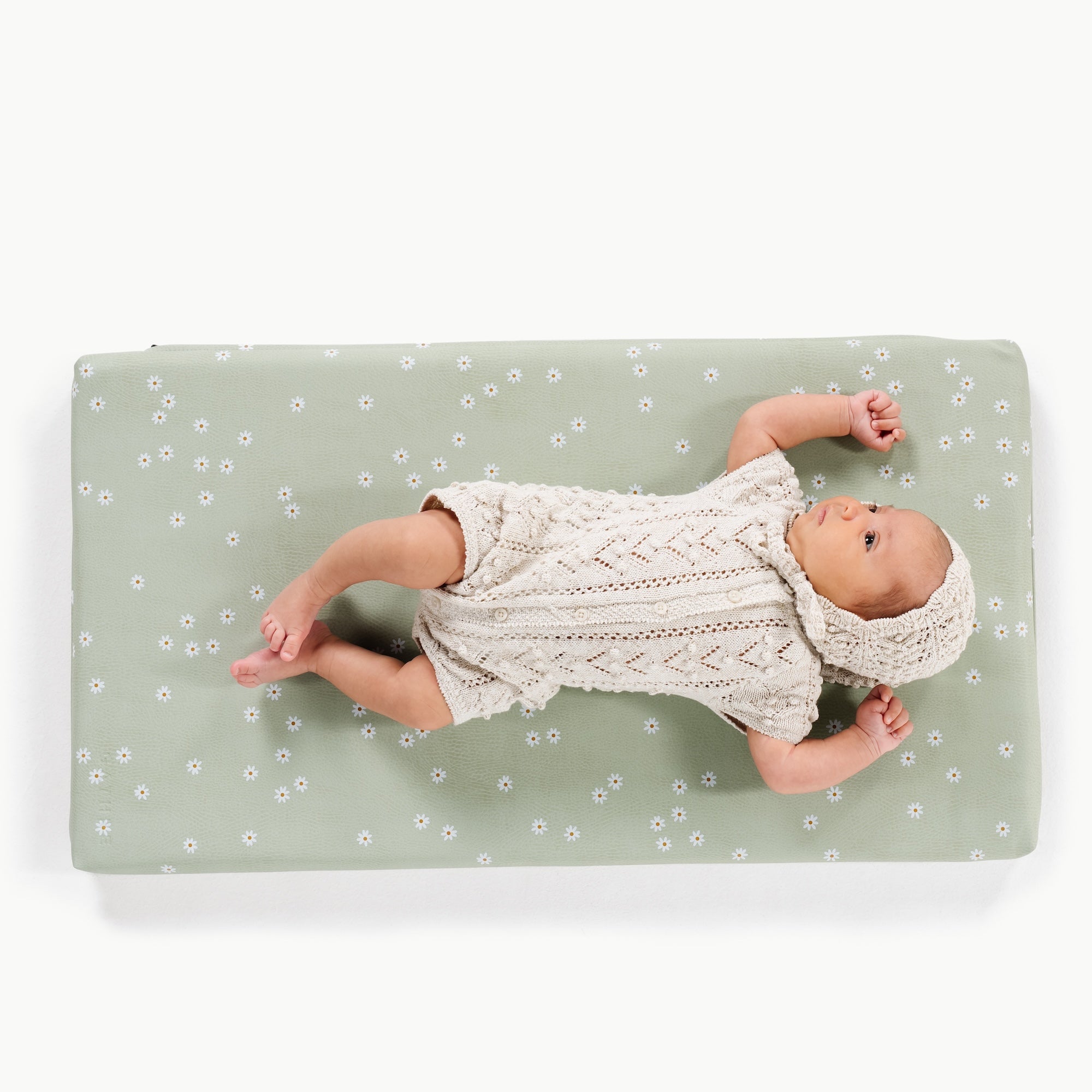 Flora@overhead of baby on a padded micro+