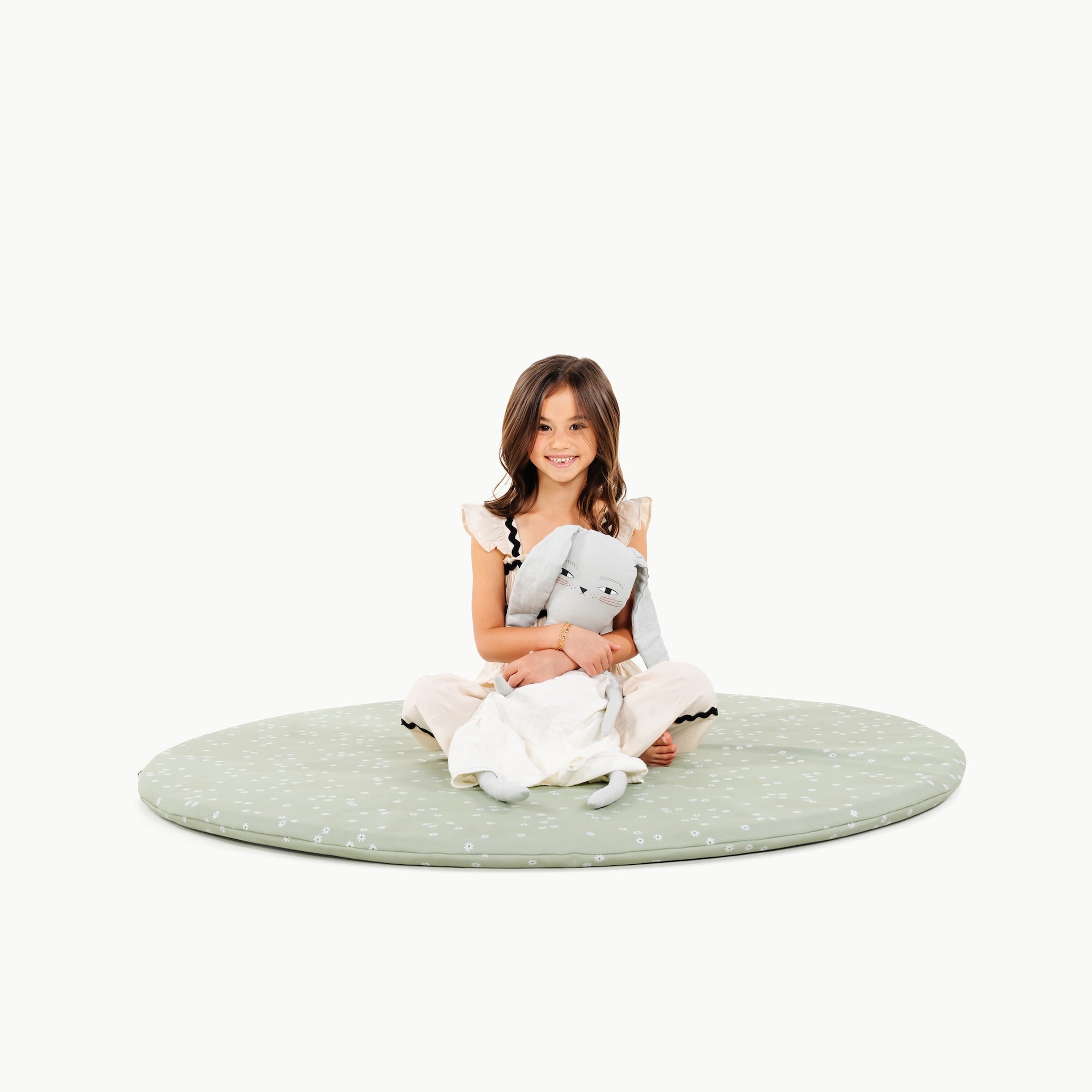 Flora@little girl sitting on padded mat