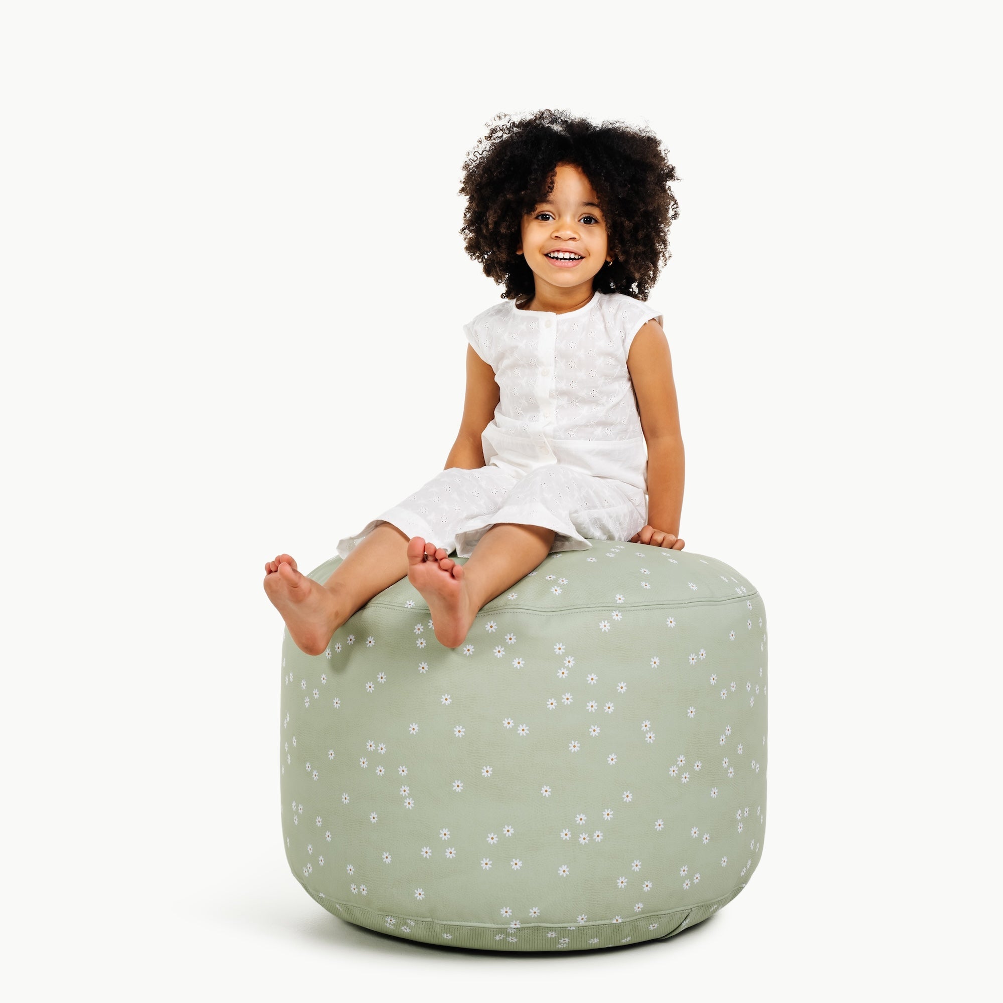 Flora@little girl sitting on pouf