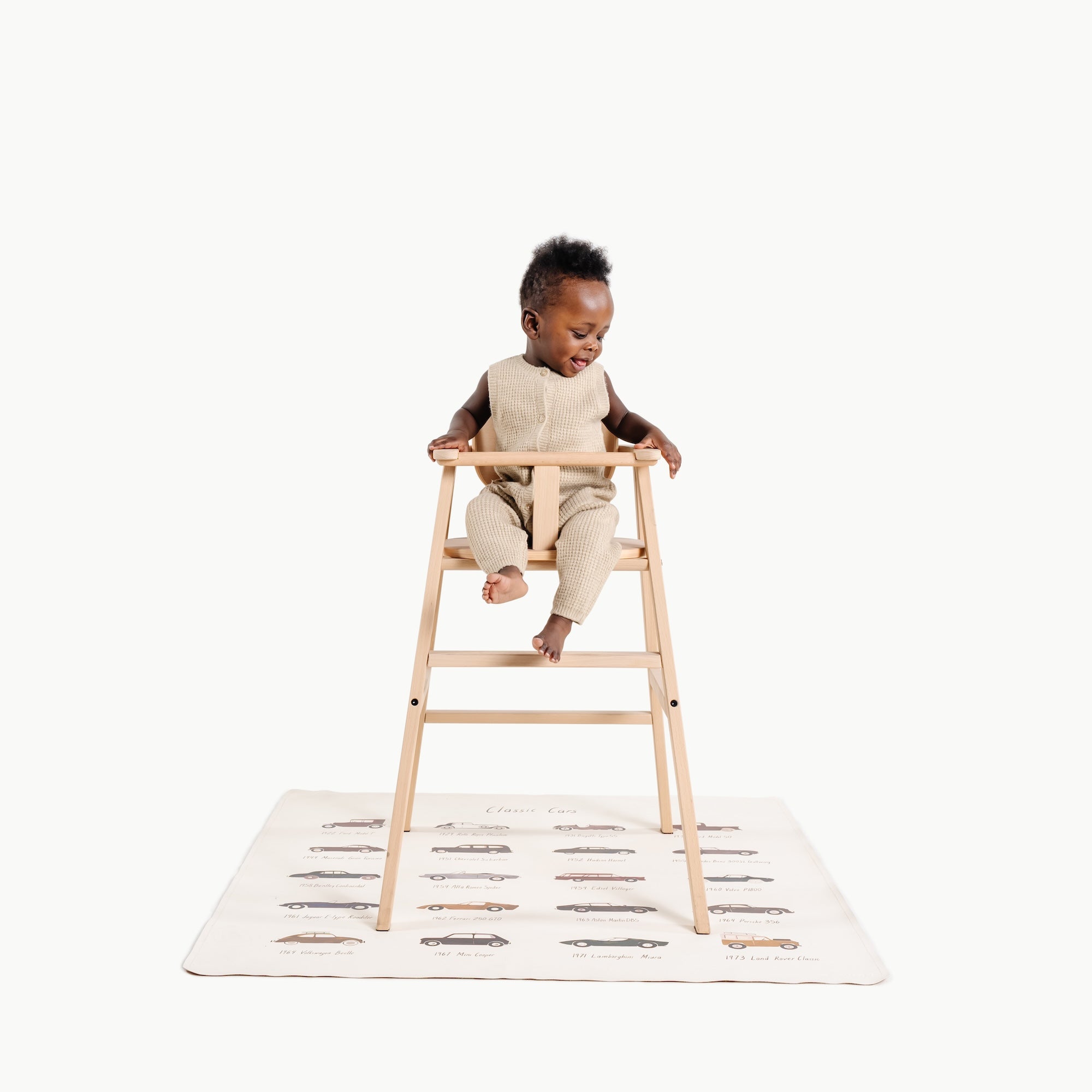 Classic Cars@little boy in a high chair on a mini mat