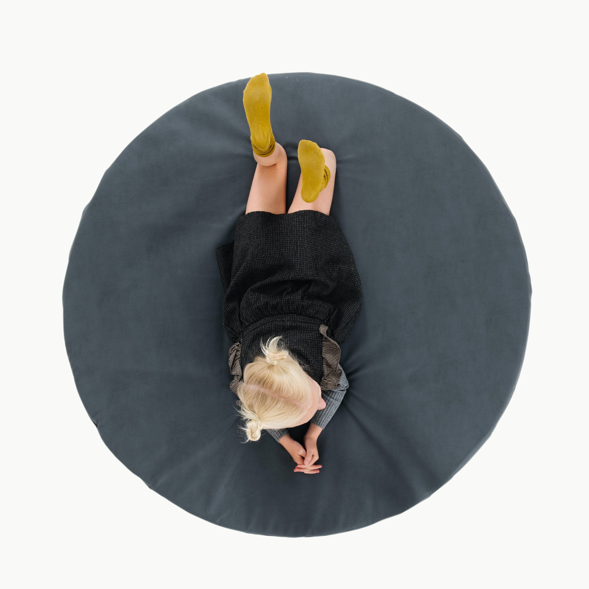Nightfall (on sale)@overhead of kid laying on the nightfall padded midi circle