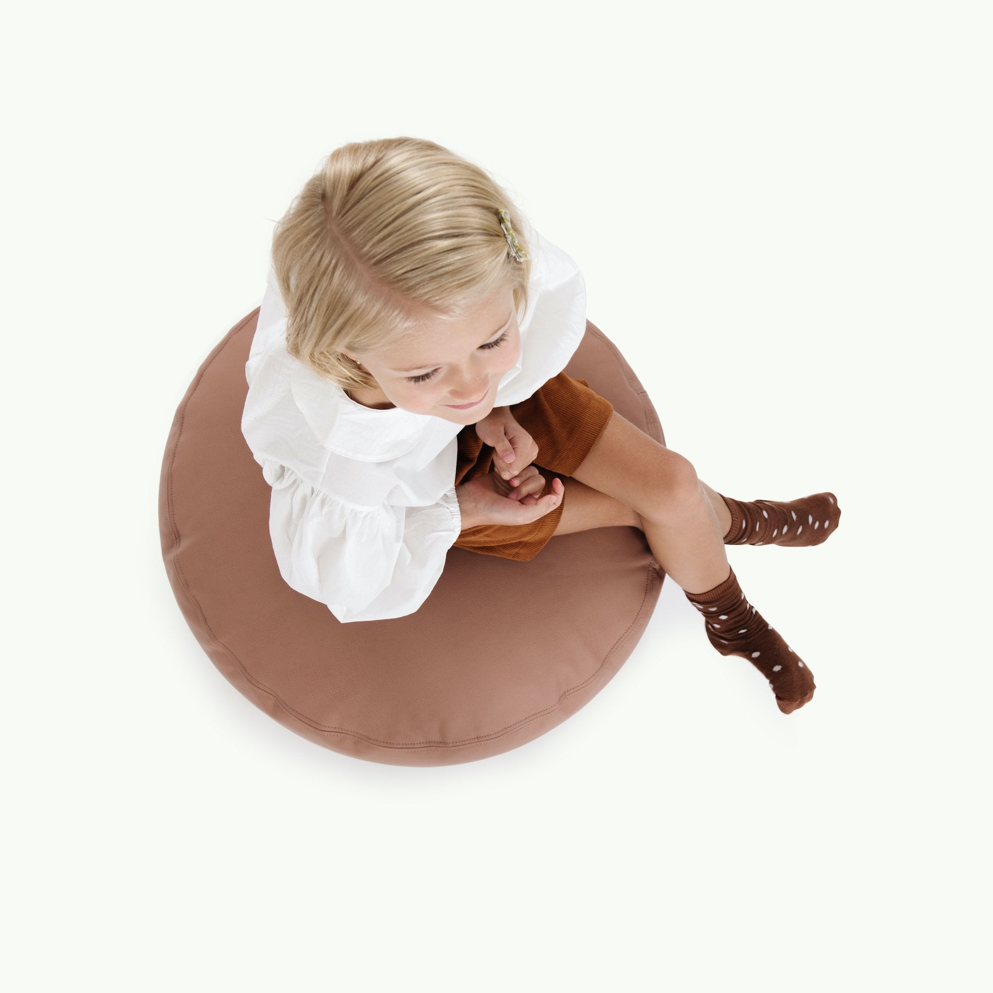 Sienna (on sale)@Overhead of kid sitting on the Sienna Circle Pouf