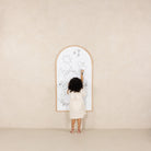 Beech@Kid drawing on the whiteboard side of the Chalkboard hanging on a wall