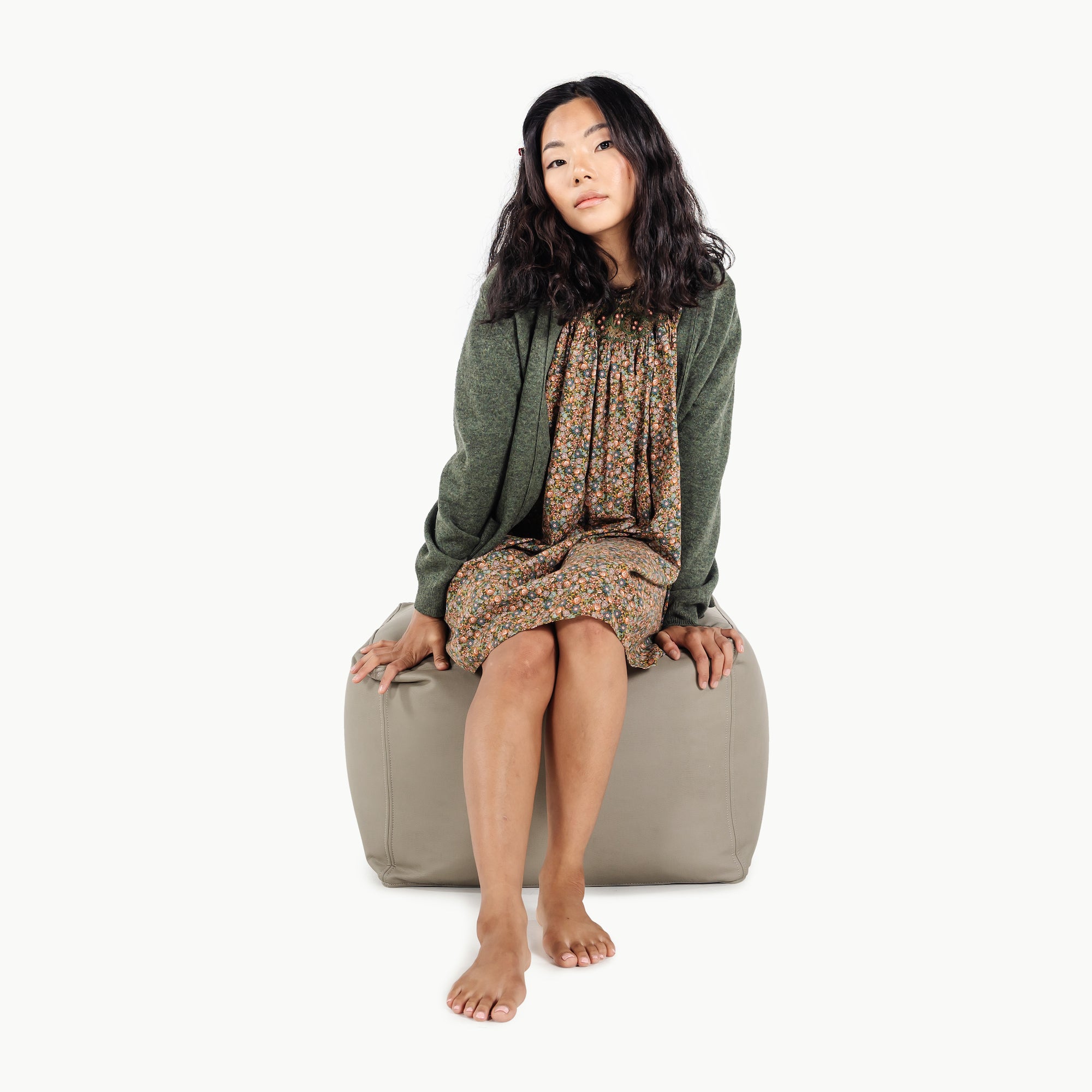 Grove (on sale)@woman sitting on the grove square pouf