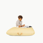 Mellow/ Square@little boy sitting on a floor cushion