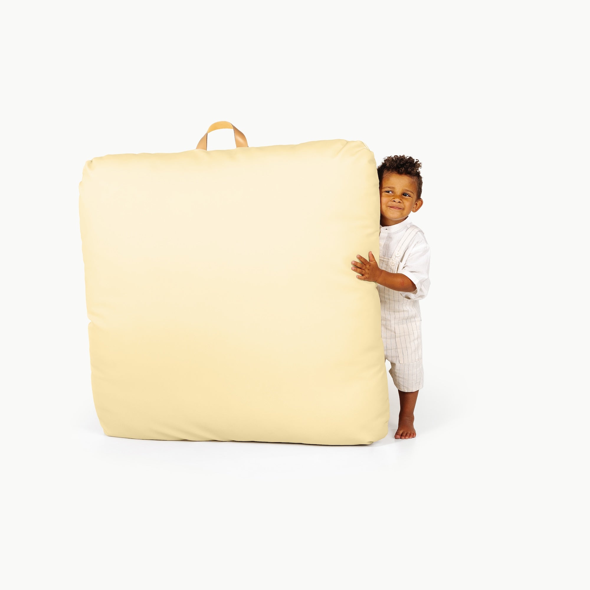 Mellow/ Square@little boy holding a floor cushion