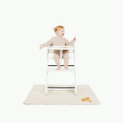 Ivory@baby sitting in highchair on the Ivory Mini Mat
