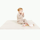 Ivory@baby sitting on the Ivory Mini Mat