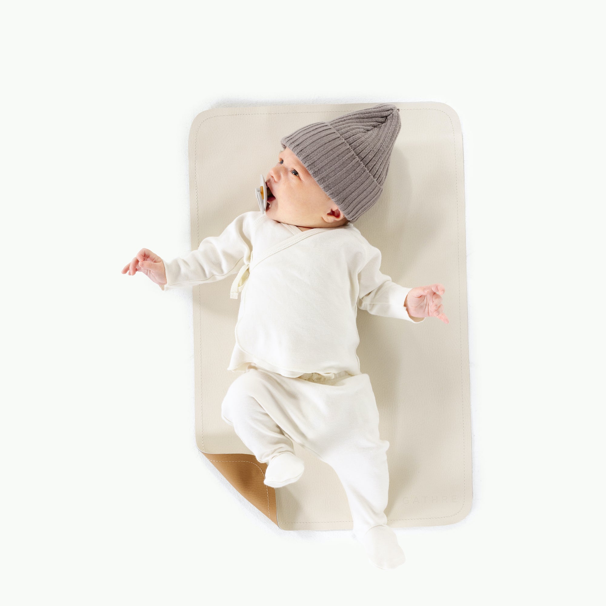 Camel • Ivory (on sale)@overhead of baby on mat