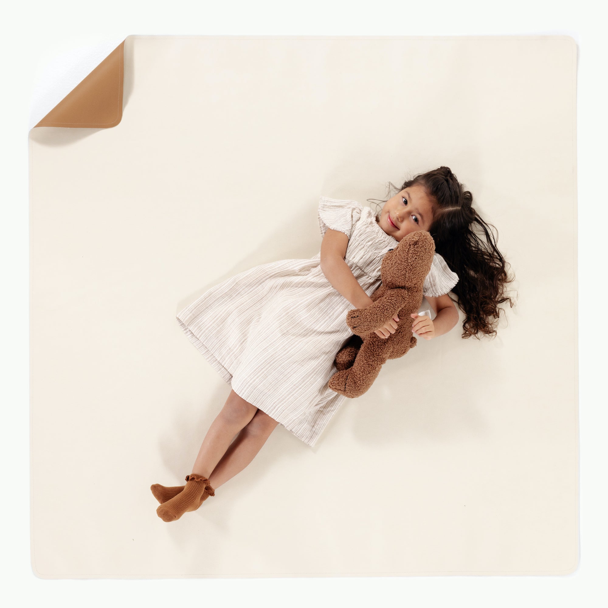 Camel • Ivory (on sale) / Square@overhead of little girl sitting on mat