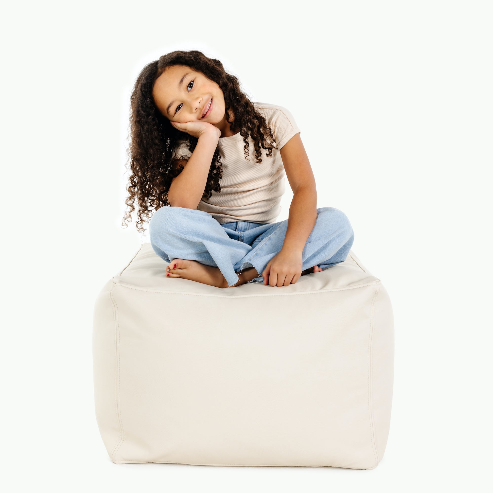 Ivory@kid sitting on the ivory square pouf