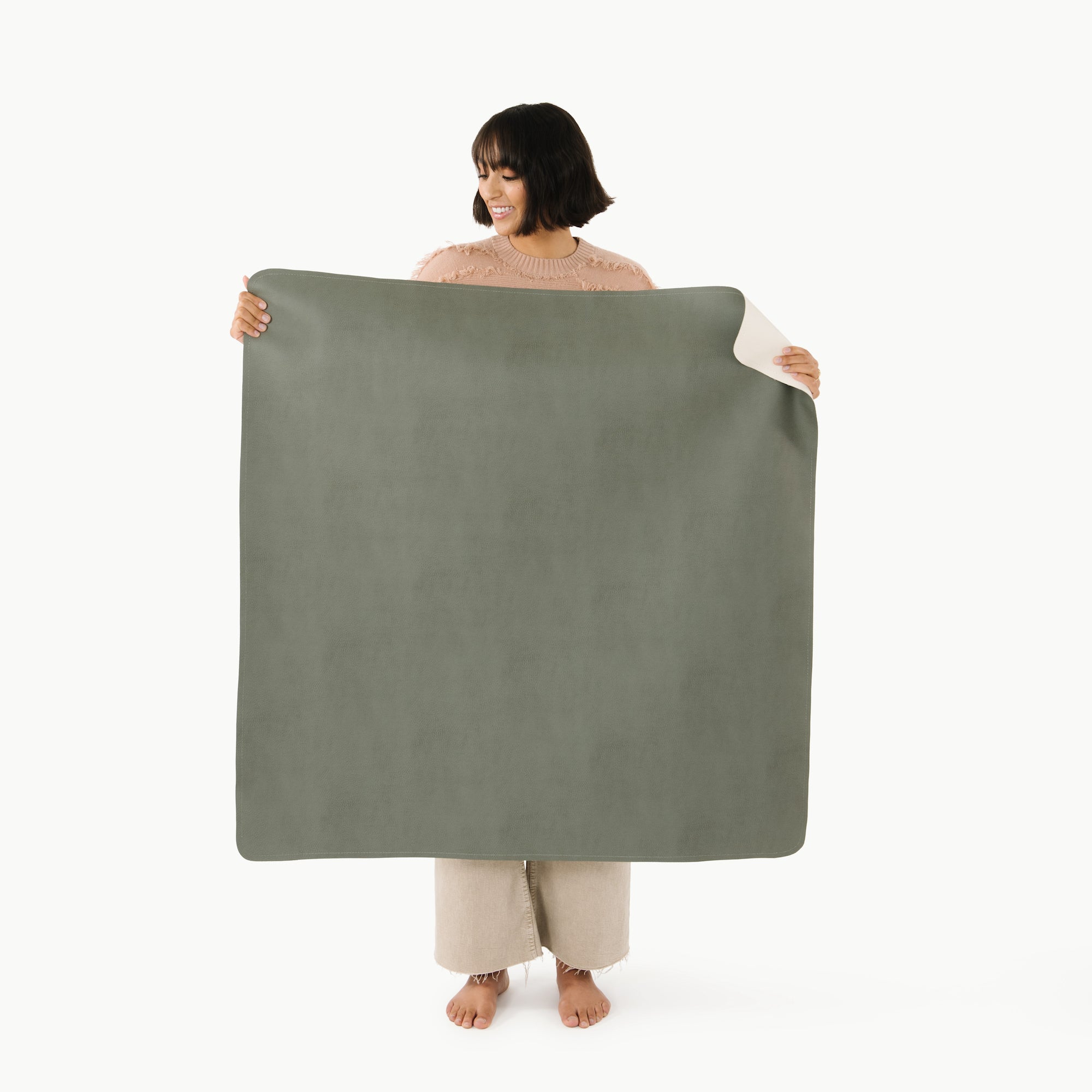 Knoll • Ivory (on sale)@woman holding the double sided knoll ivory mini mat