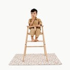 London@kid in a highchair on the london mini mat