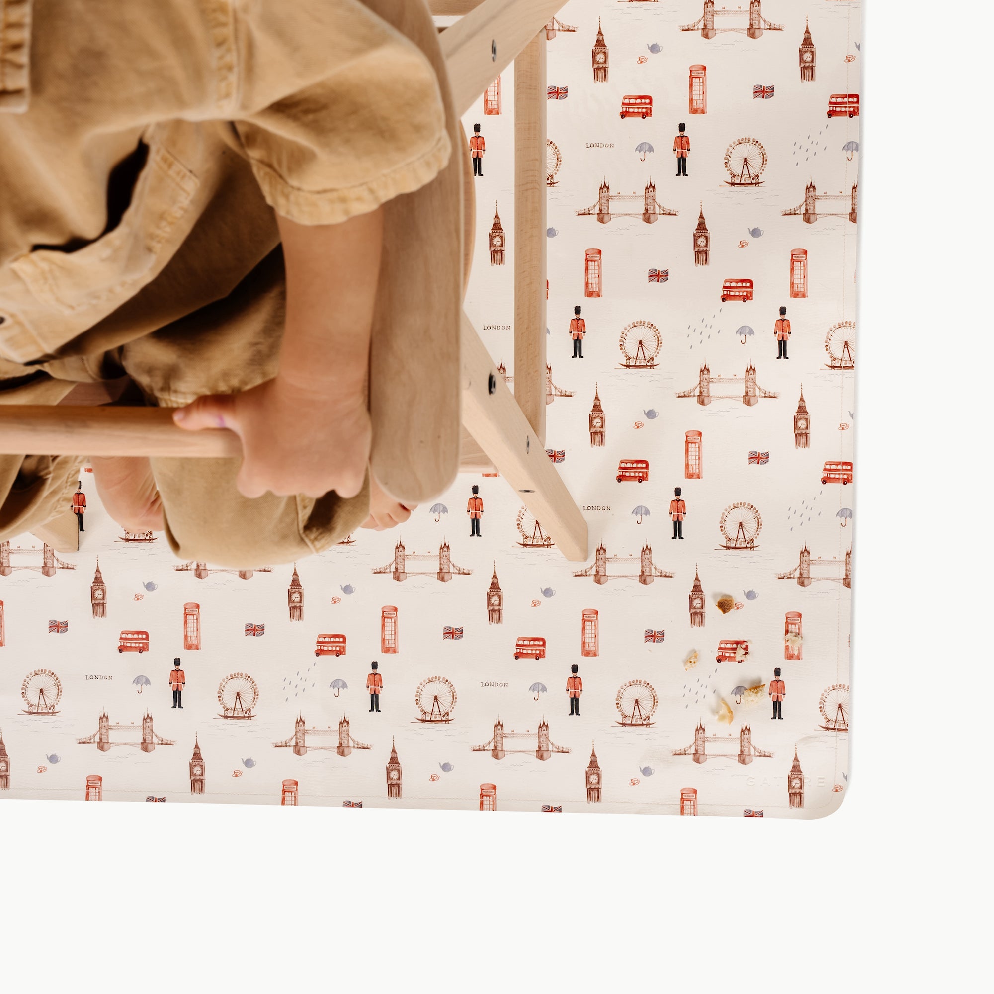 London@overhead of lkid in a highchair on the london mini