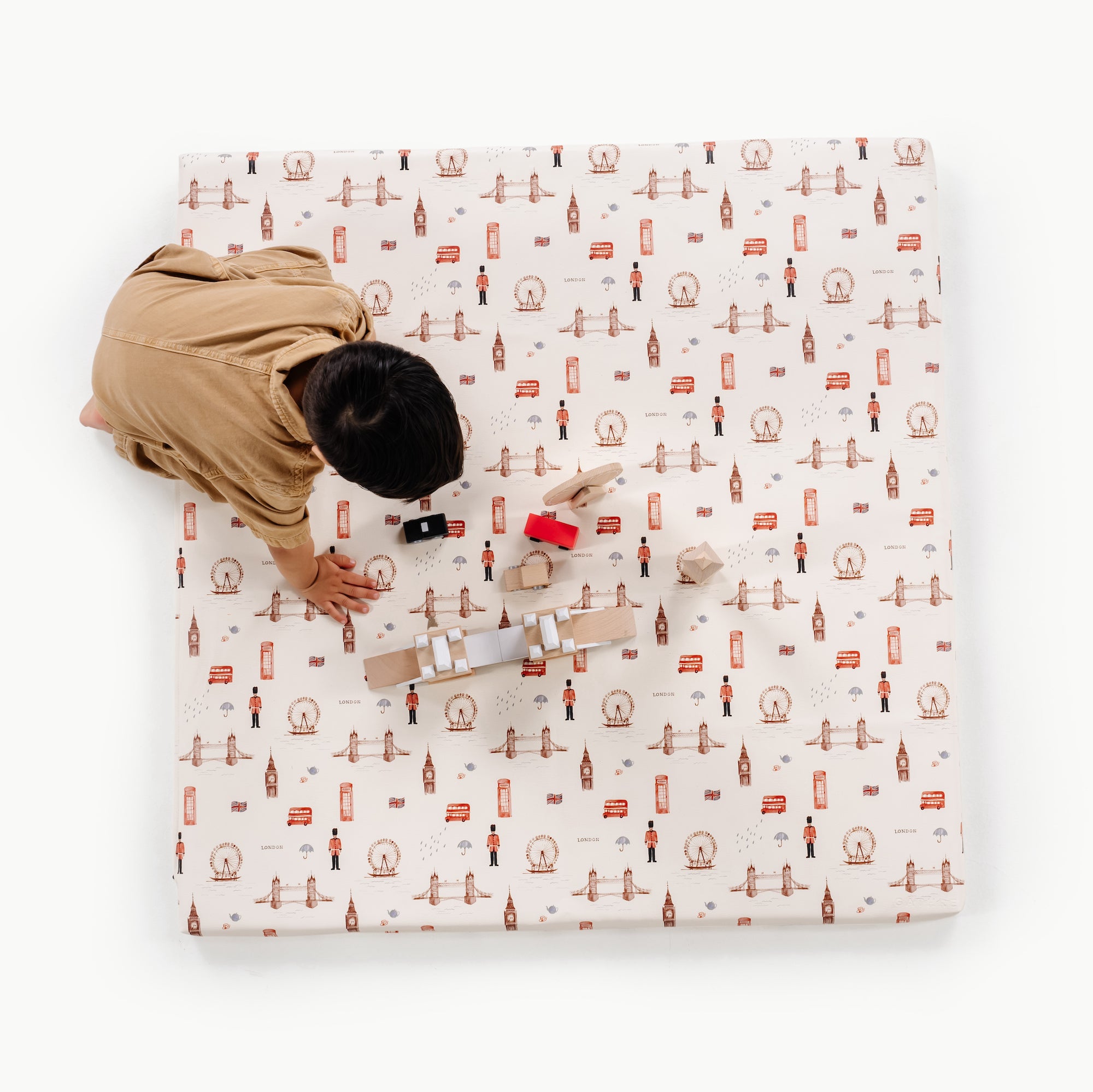 London / Square@overhead of kid playing on the london padded square mat