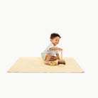 Mellow@toddler playing on a mini mat
