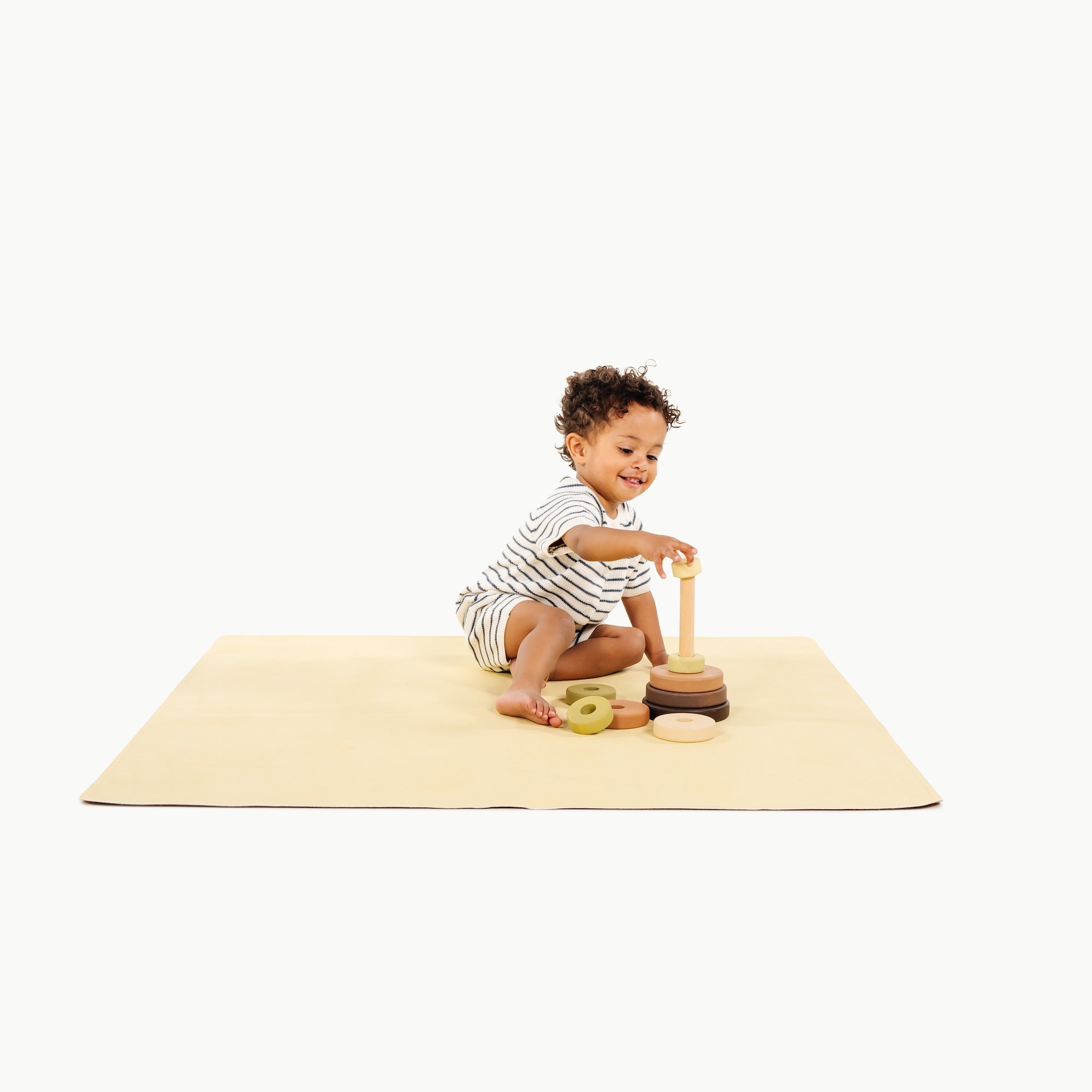 Mellow@toddler playing on a mini mat