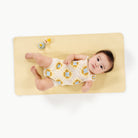 Mellow@overhead of baby laying on a micro+ changing mat