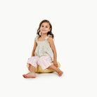 Mellow / Circle@little girl sitting on a mini cushion