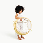 Mellow@toddler holding folded tunnel