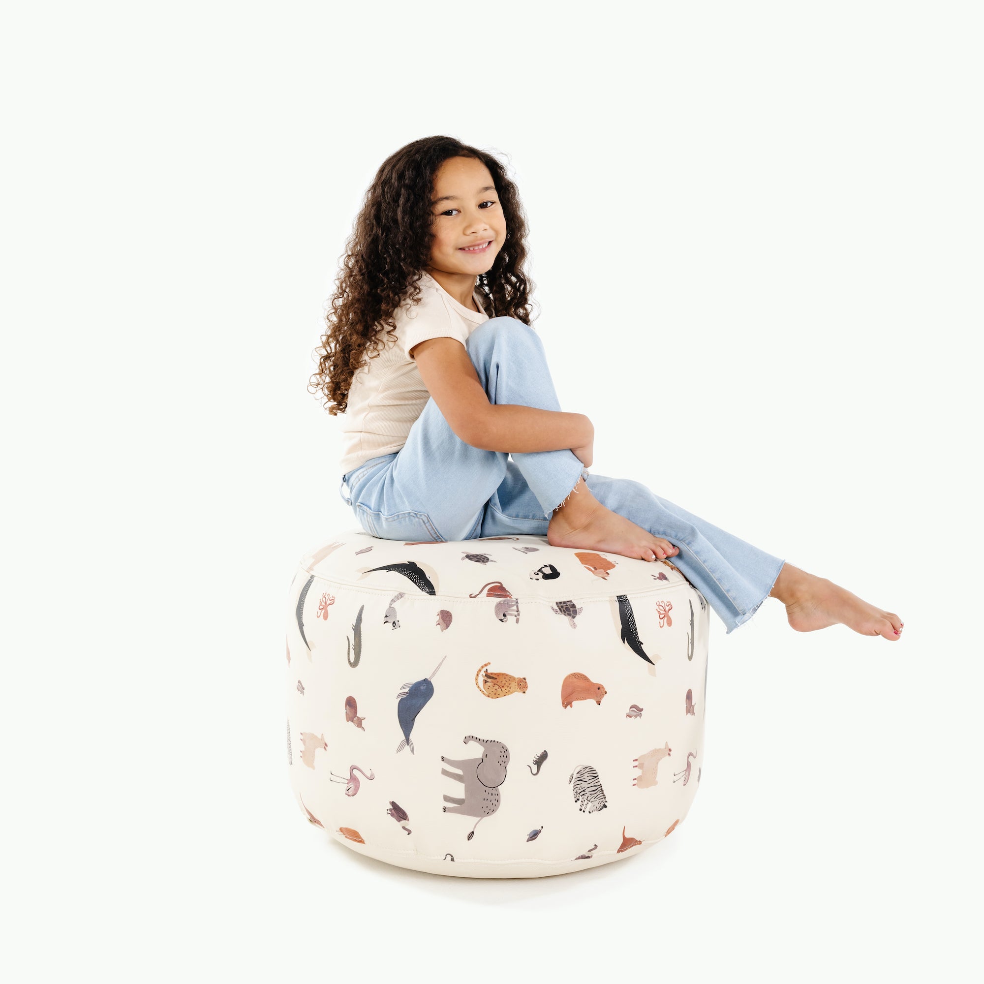 Menagerie@kid sitting on the menagerie circle pouf