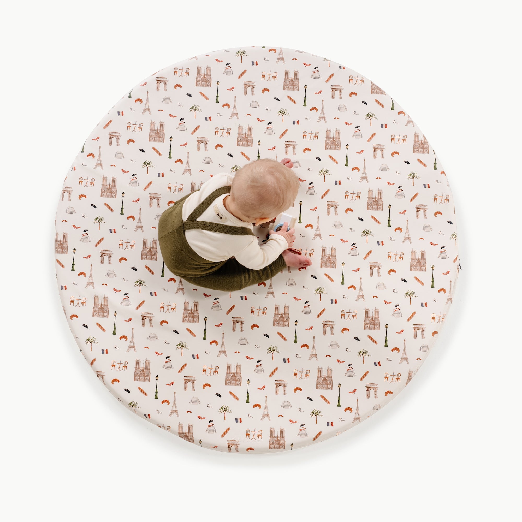 Paris / Circle@overhead of kid playing on the paris padded mini circle mat