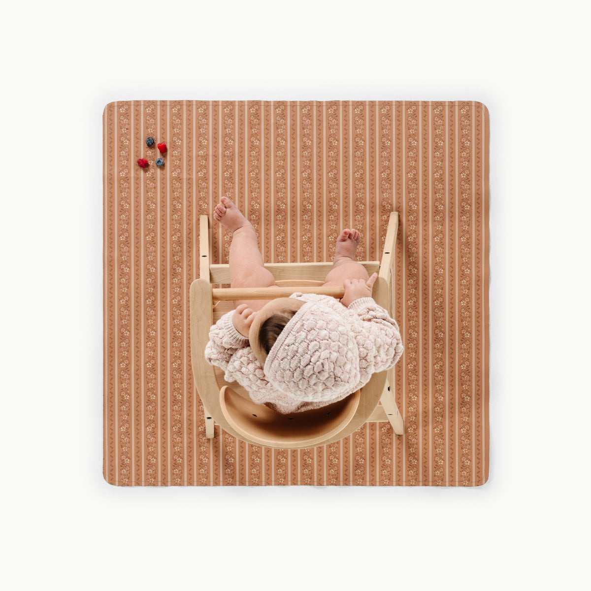 Floral Stripe@overhead of a child in a highchair on the mini mat
