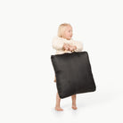 Raven (on sale) / Square@Little girl holding the Raven Mini Square Floor Cushion