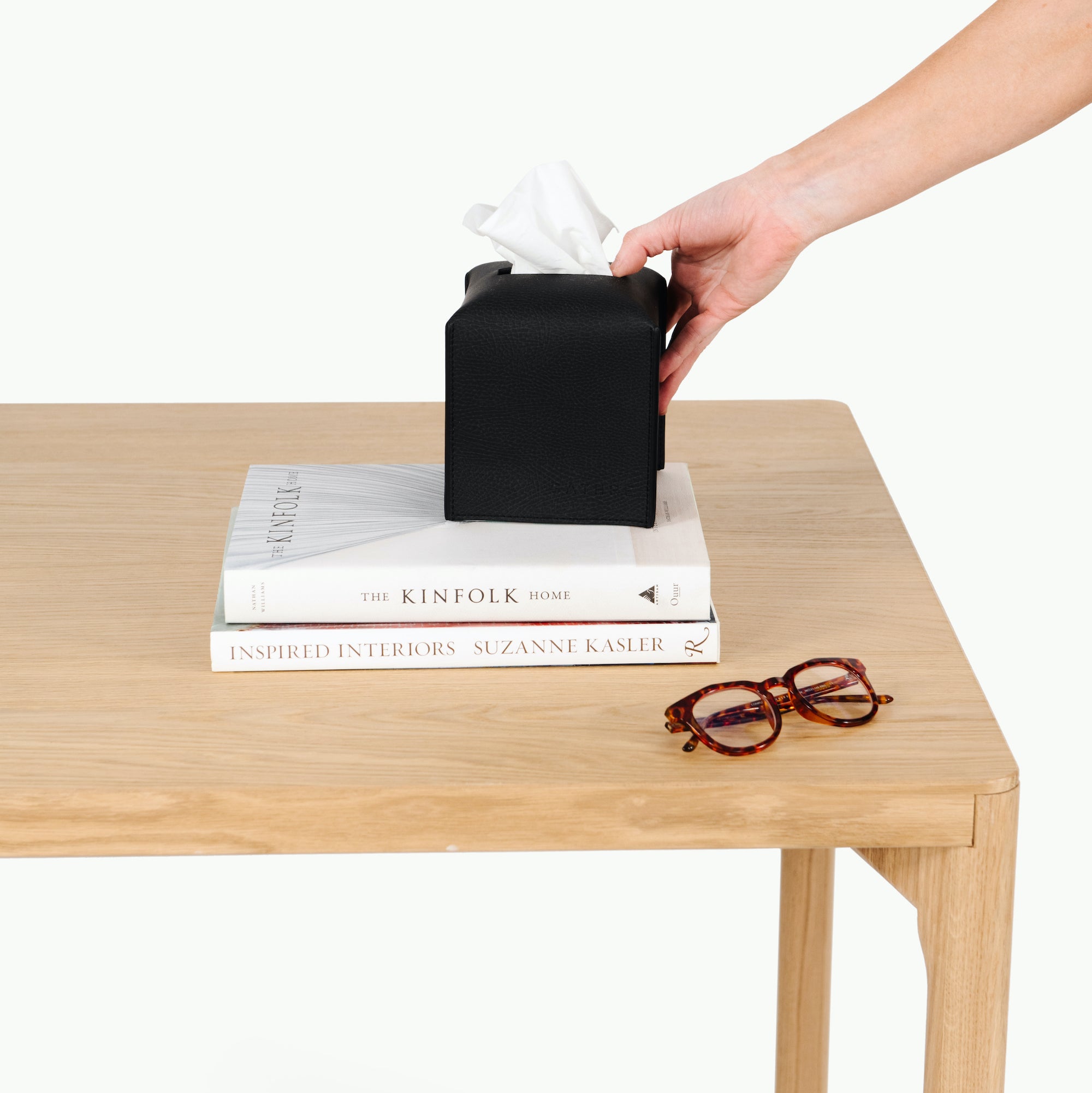 Raven (on sale)@Raven Tissue Cover on a side table with books and a pair of glasses